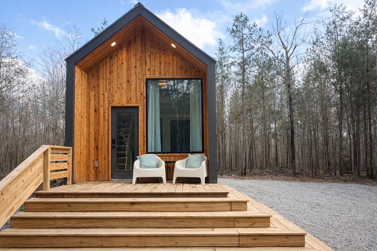 Cabin front-door exterior framed by hardwoods
